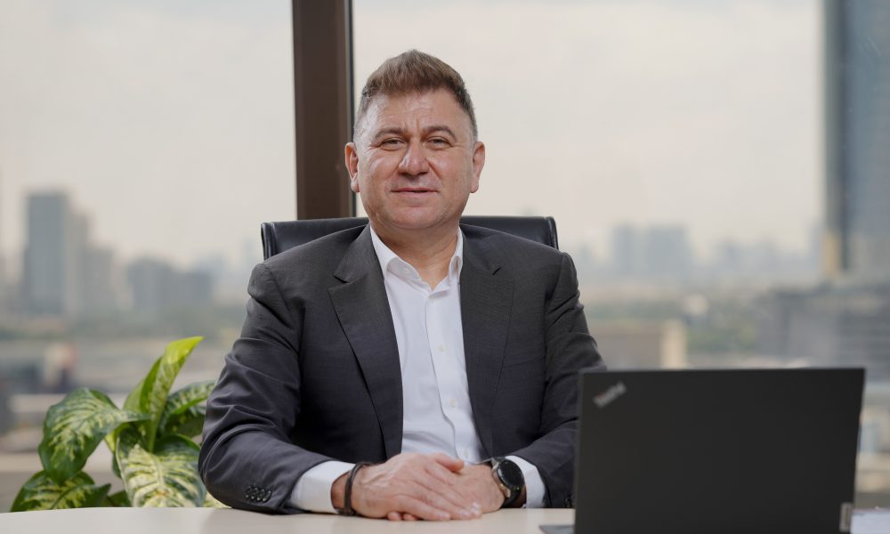 A businessman sitting at the desk with a laptop
