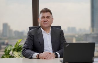 A businessman sitting at the desk with a laptop