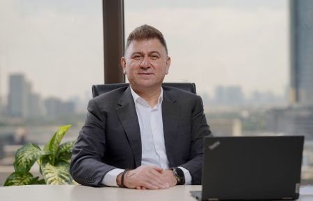A businessman sitting at the desk with a laptop