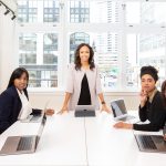 Woman standing on the center table with four people on the side