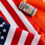 bright american flag with roll of greenbacks